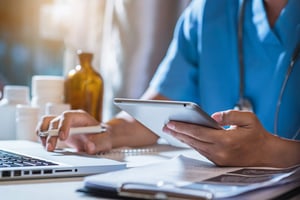 Business person reading emails on smartphone and laptop computer screen