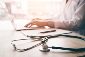 doctor using laptop at his desk