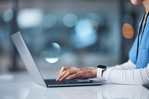 close up of nurse using their laptop