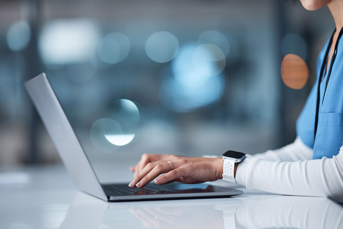 close up of nurse using their laptop